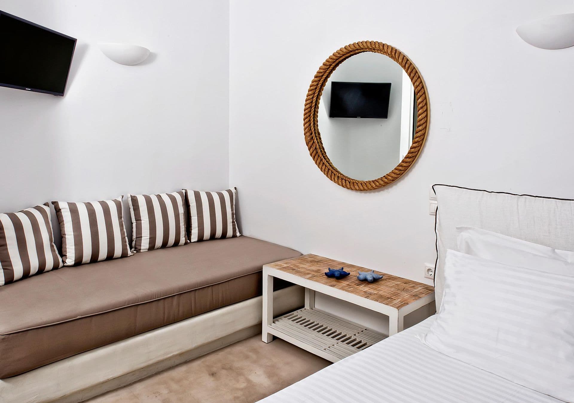 Bedroom with a wrought-iron bed frame and bedside lamps at Grecian Gazing