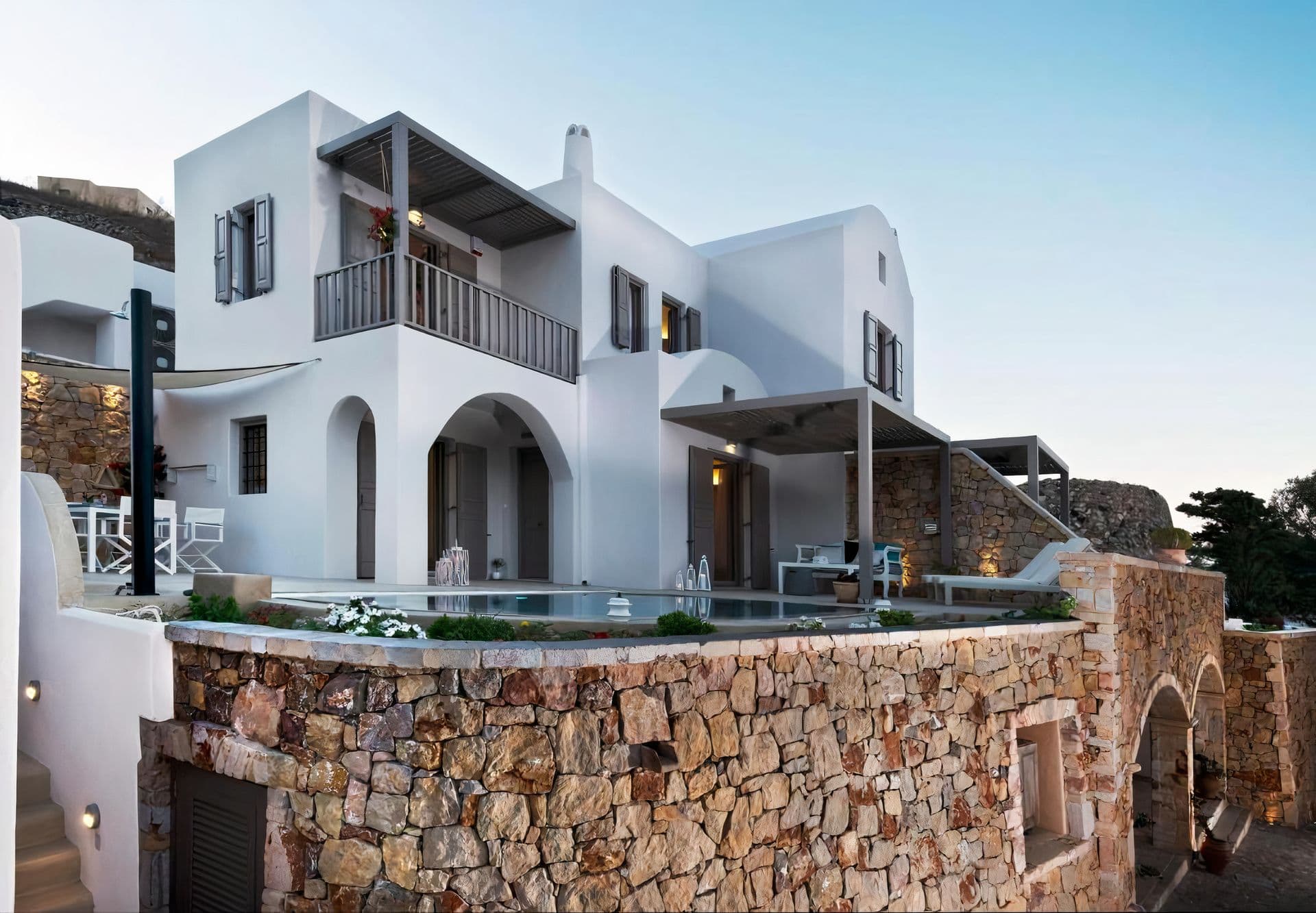 Whitewashed Cycladic building facade with balconies at Grecian Gazing
