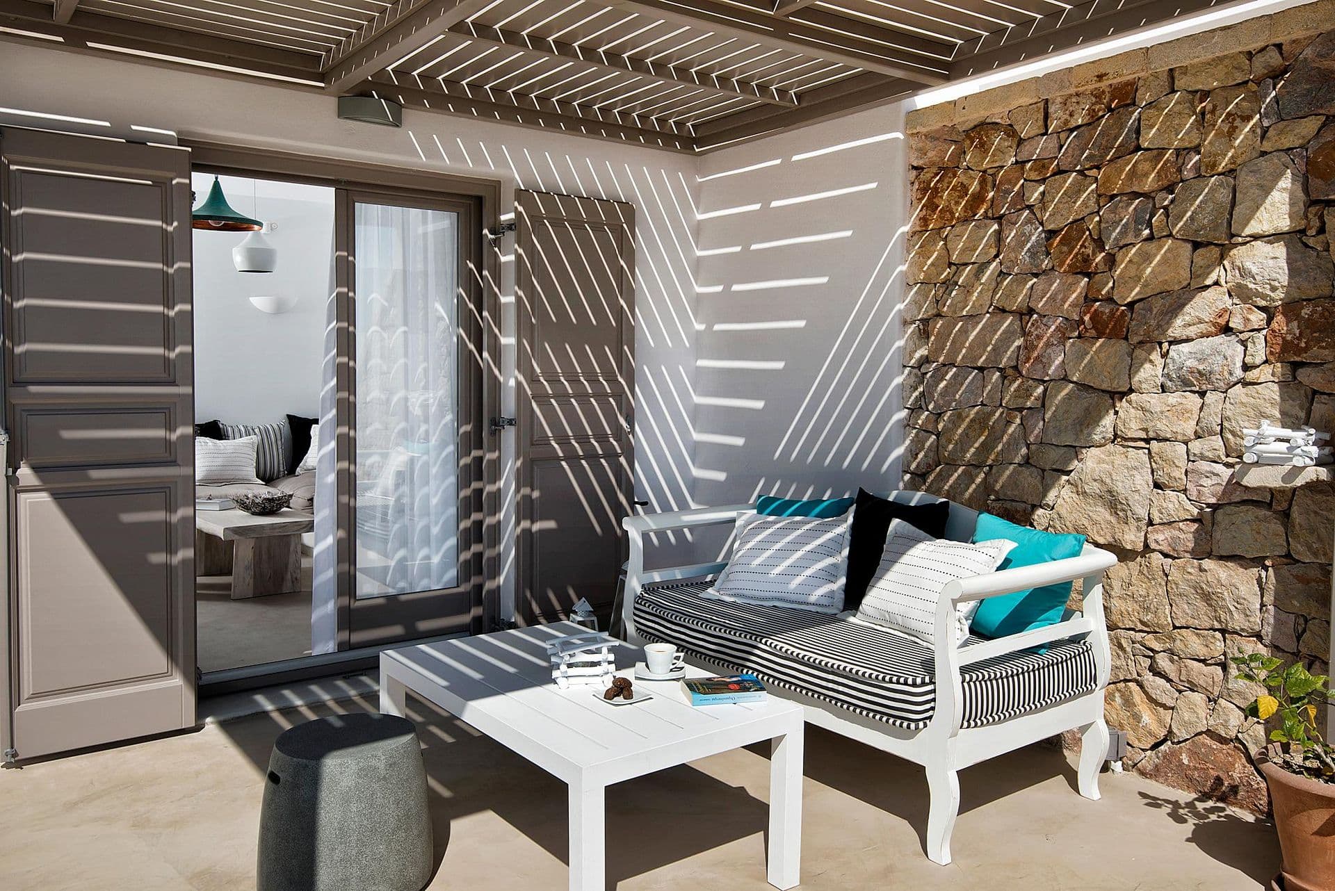 Sun loungers on a stone-walled terrace with sea view at Grecian Gazing
