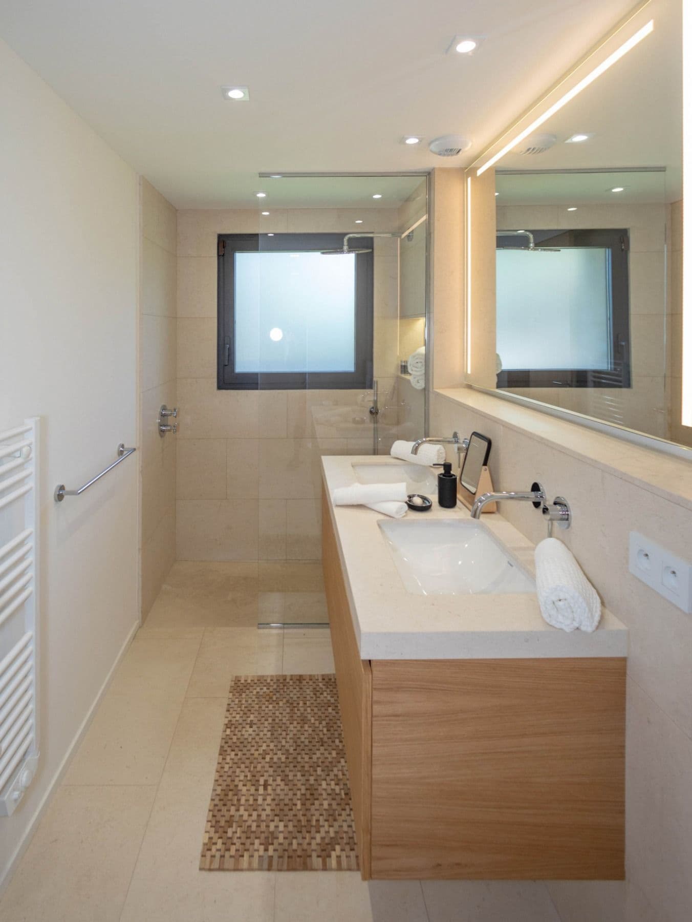Bathroom with a double vanity and walk-in shower below clerestory windows at Brilliant Sea, Saint-Tropez