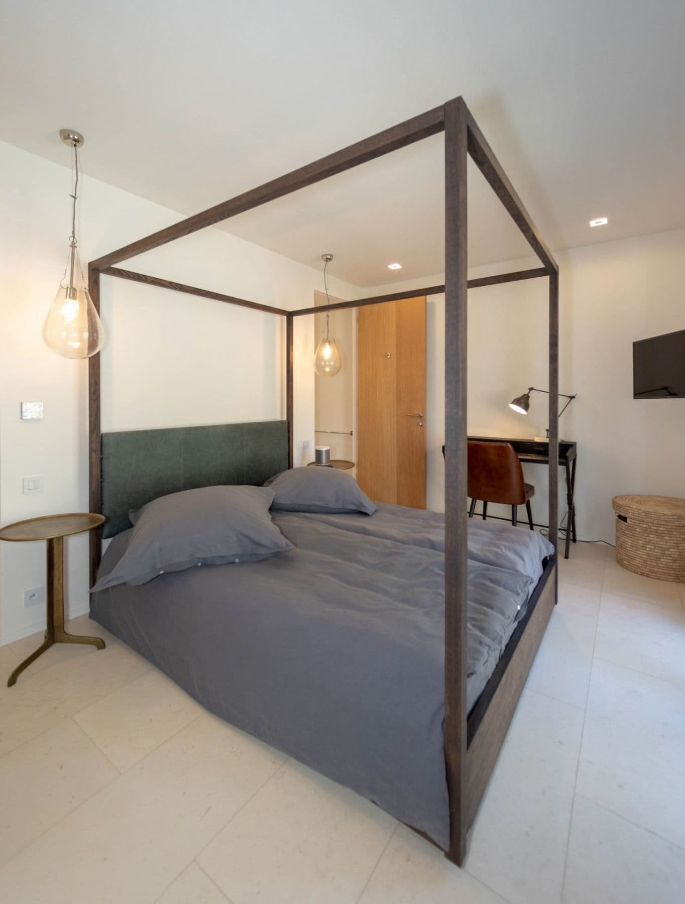 Double bedroom with a timber four-poster in grey linen at Brilliant Sea, Saint-Tropez