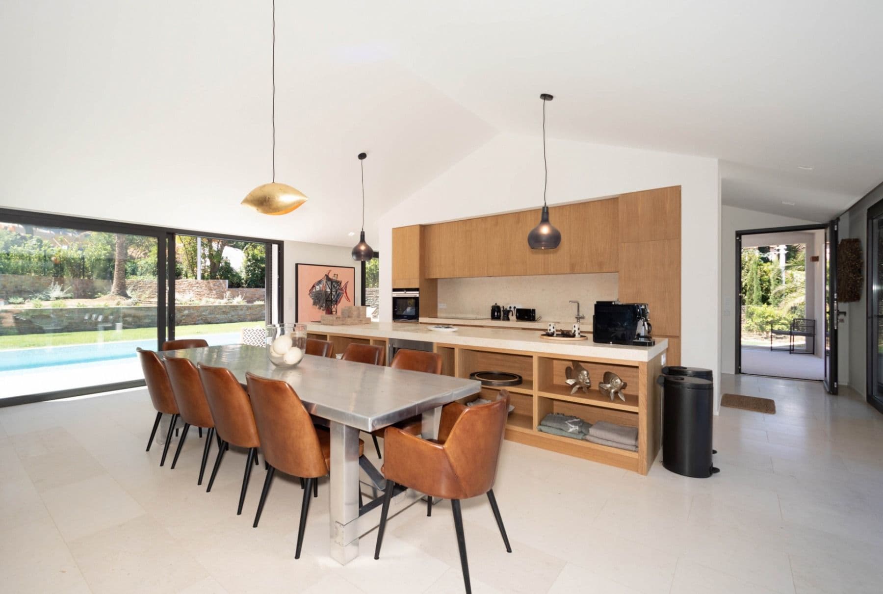 Kitchen bar and dining table with pool views at Brilliant Sea, Saint-Tropez