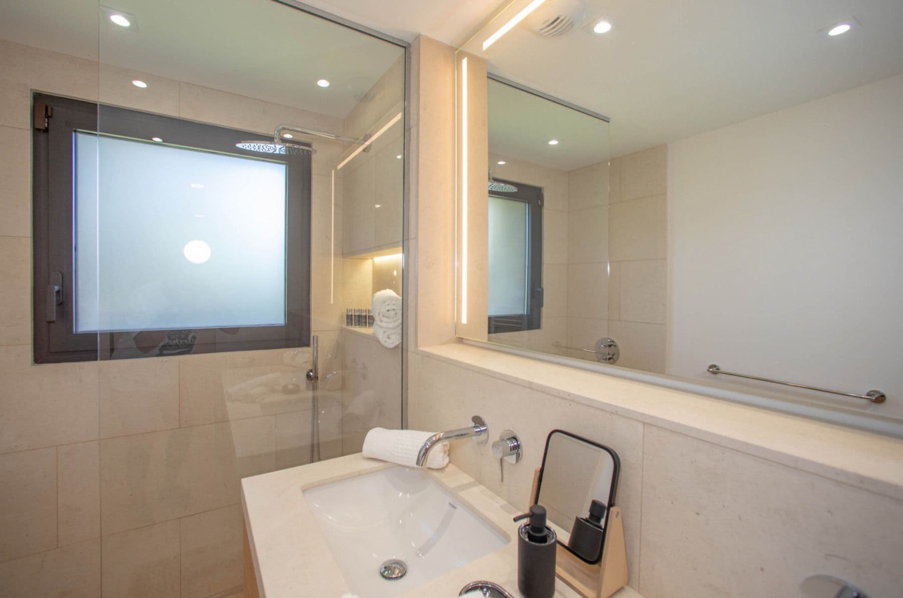 Shower room with an oak vanity and a window over the garden at Brilliant Sea, Saint-Tropez