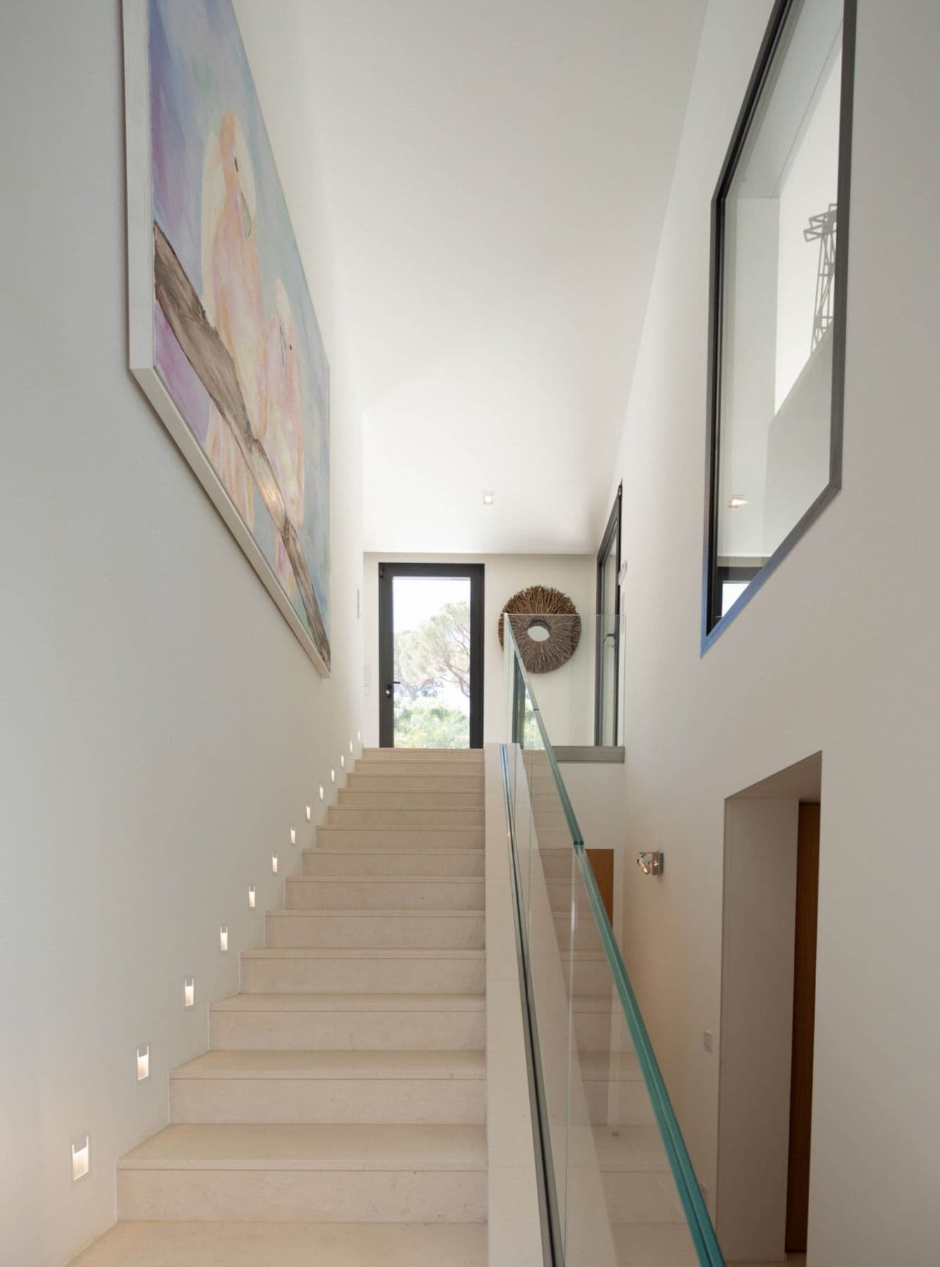 Travertine staircase with a glass balustrade at Brilliant Sea, Saint-Tropez