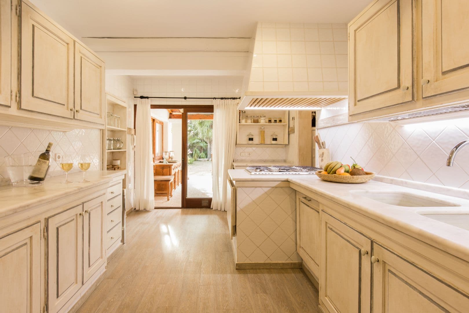 Traditional kitchen with cream cabinetry and tiled splashback
