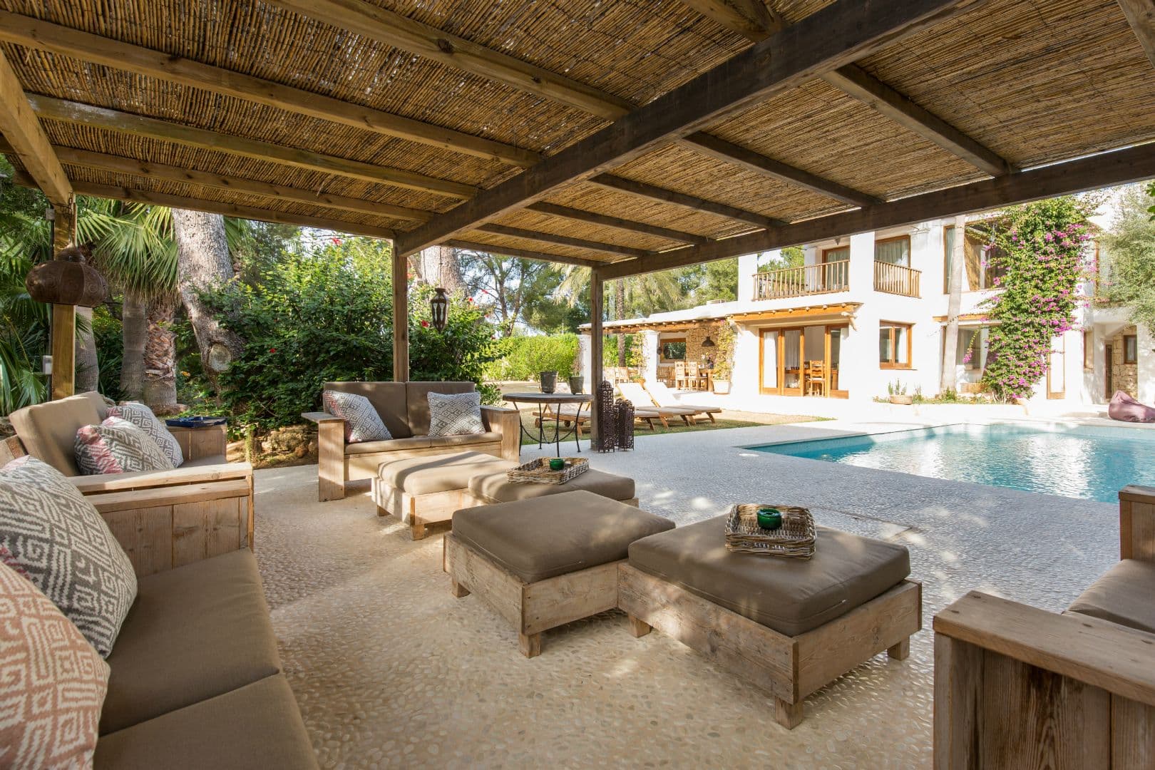 Terrace lounge seating overlooking the pool at dusk