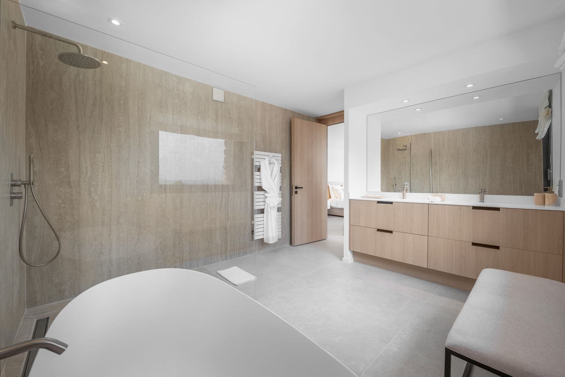 En-suite with a freestanding tub, double vanity and mirror at Alpilles Retreat, Provence