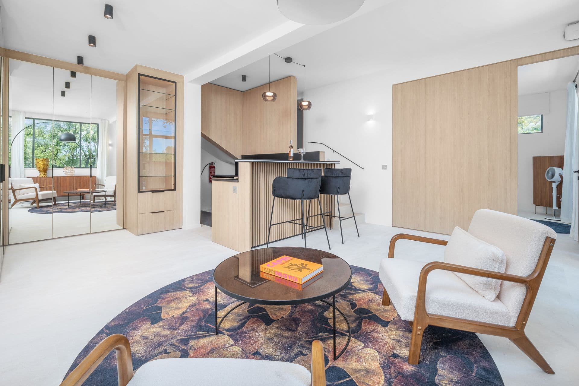 Reception area with an oak bar, mirrored wall and the staircase at Alpilles Retreat, Provence