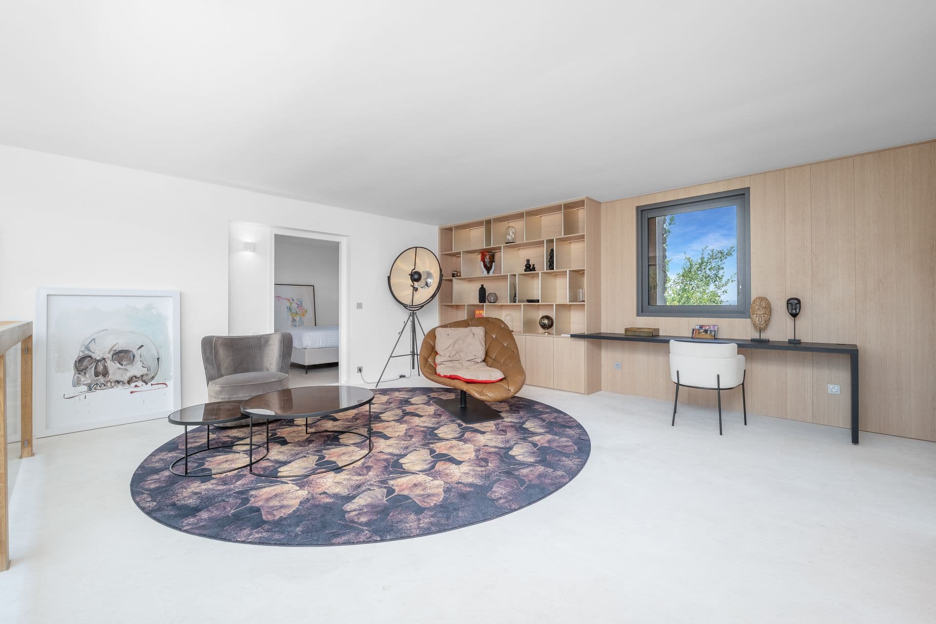 Study and reading room with a desk, shelving and a round rug at Alpilles Retreat, Provence