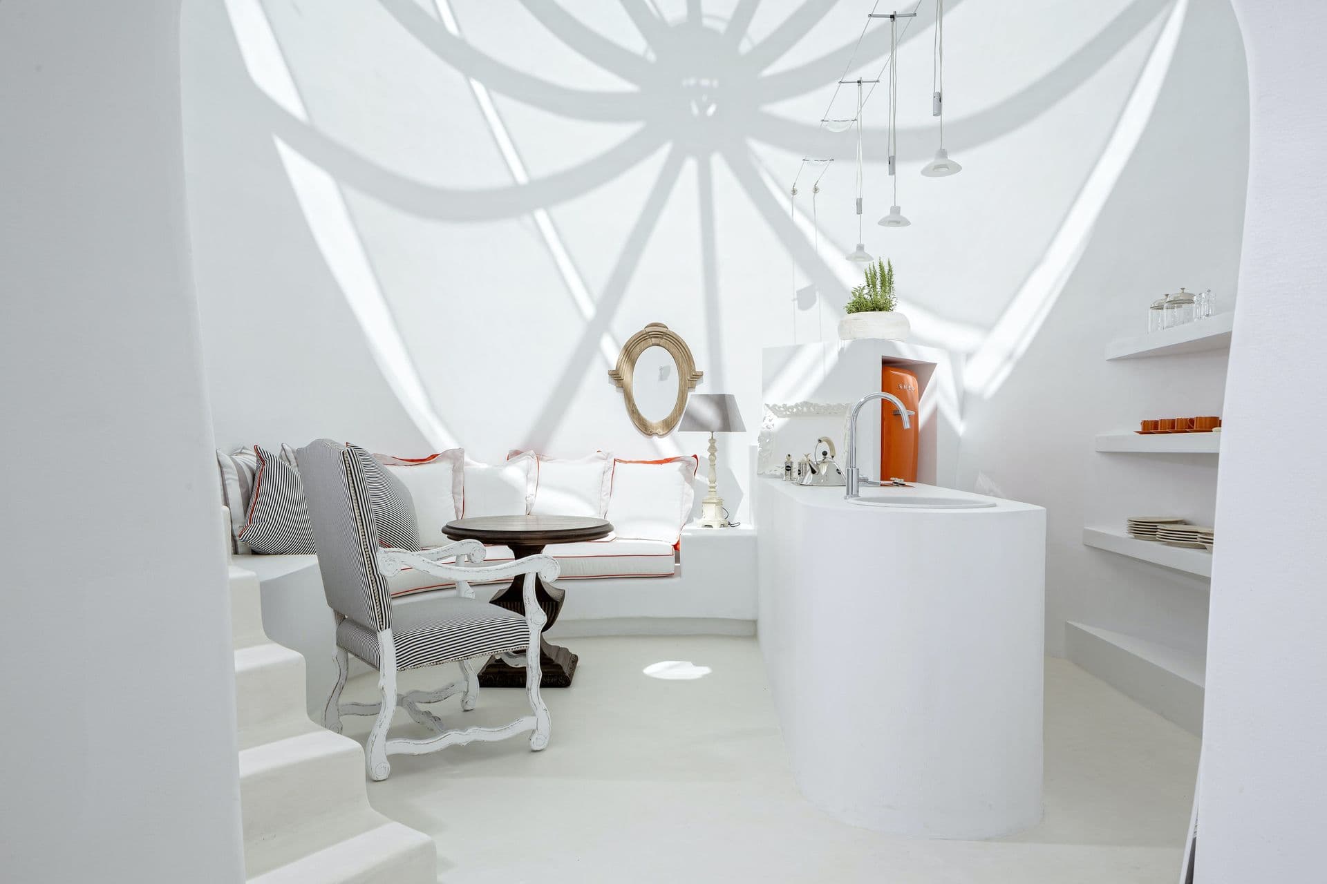 Sculptural white domed room with a sunburst skylight at Calypso Dream, Santorini
