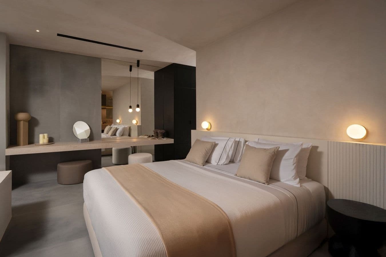 Bedroom with neutral linens and a black feature wall