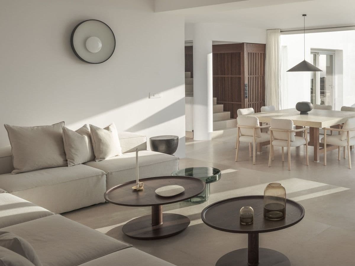 Open-plan living and dining space with sea view through large windows
