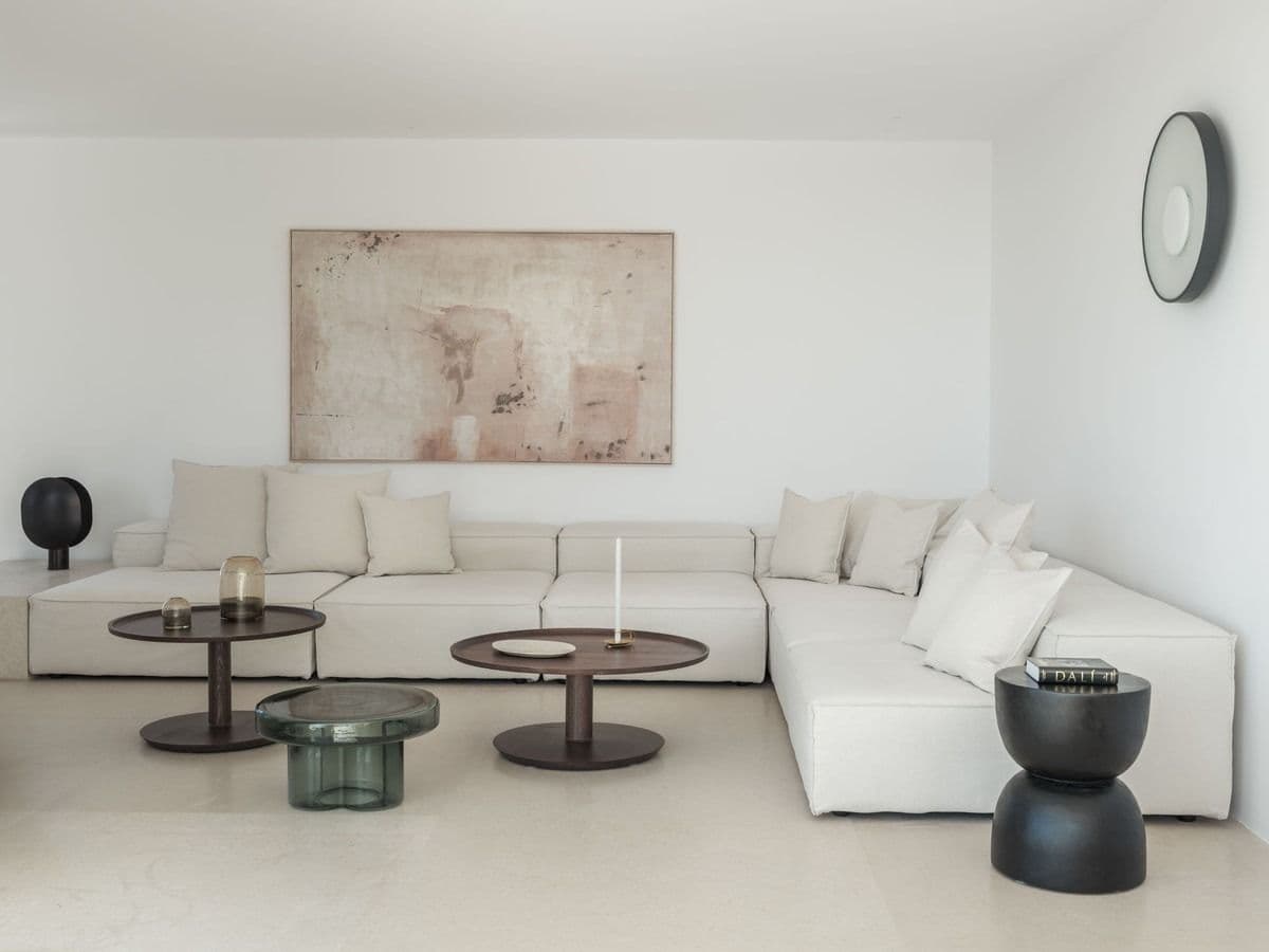 Minimalist living room with a white L-shaped sectional sofa