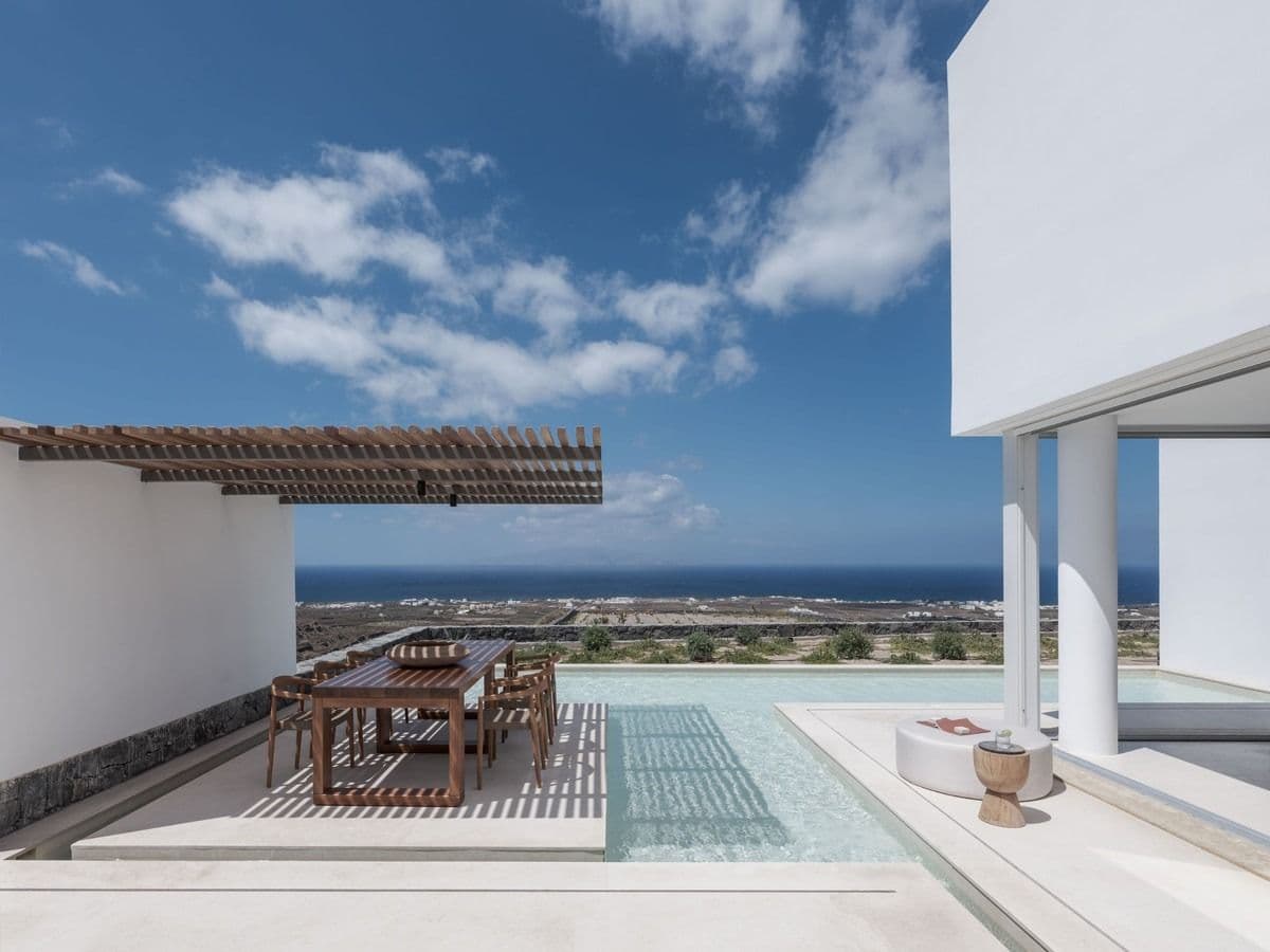 Santorini villa pool terrace with white cycladic architecture and sea view