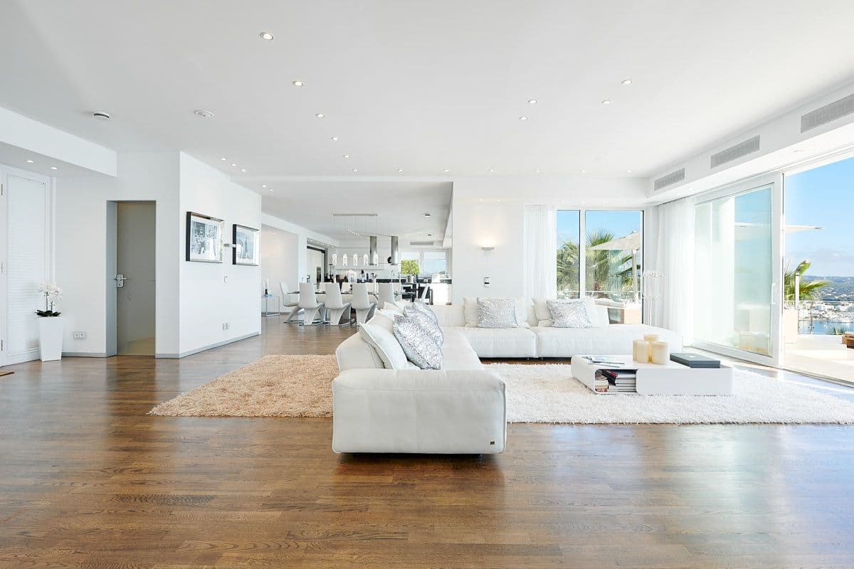 Open-plan white living room opening to the pool and sea at Blue Sea Bliss, Ibiza