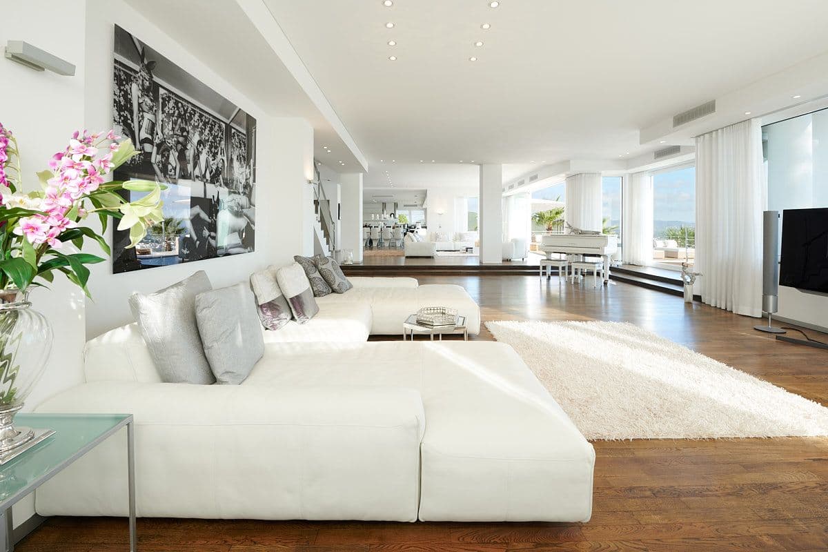 Reception lounge with a large monochrome artwork opening to the dining area at Blue Sea Bliss, Ibiza