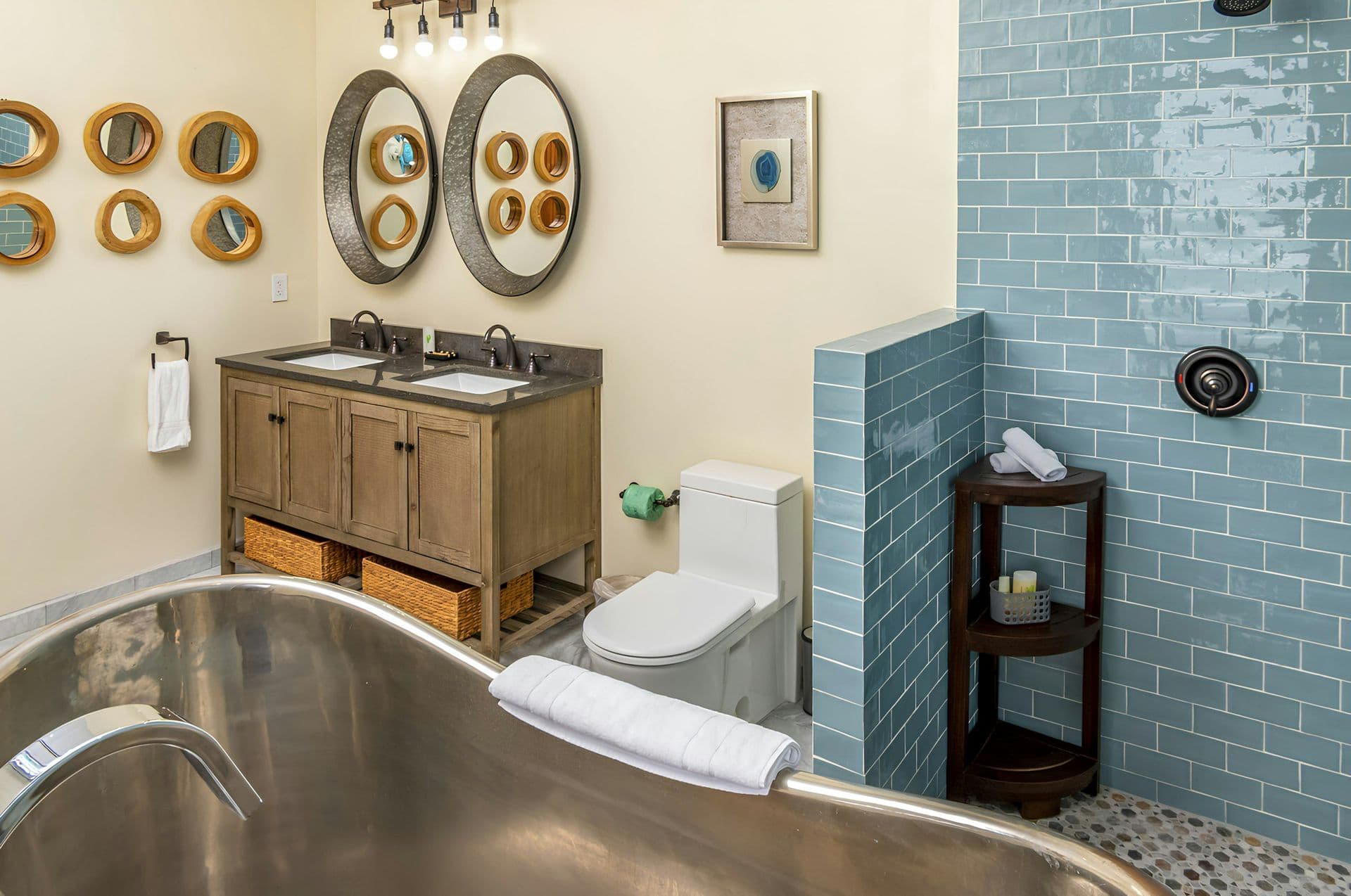 En-suite bathroom with a double vanity and steel slipper bath at Life in Love