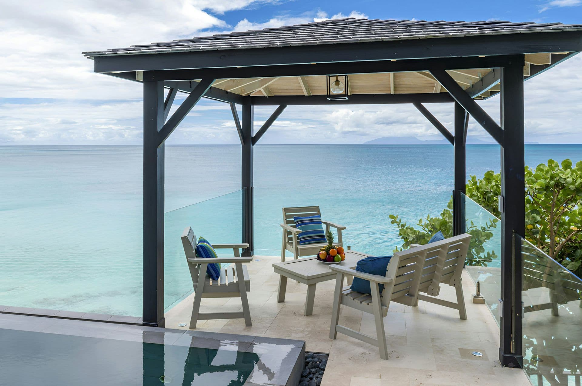 Shaded gazebo with a dining table over the sea at Life in Love, Antigua
