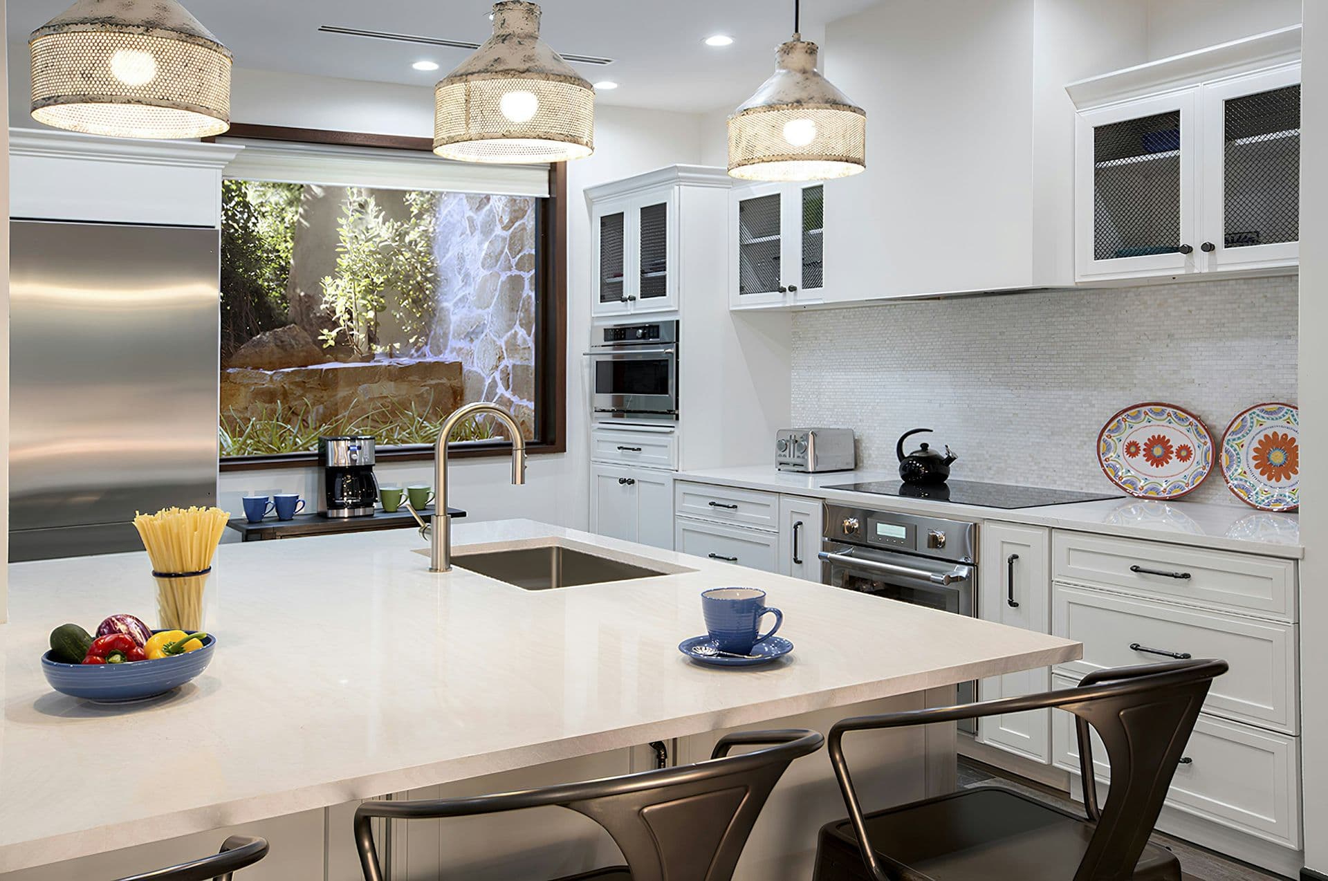 White kitchen with an island and breakfast bar at Life in Love, Antigua