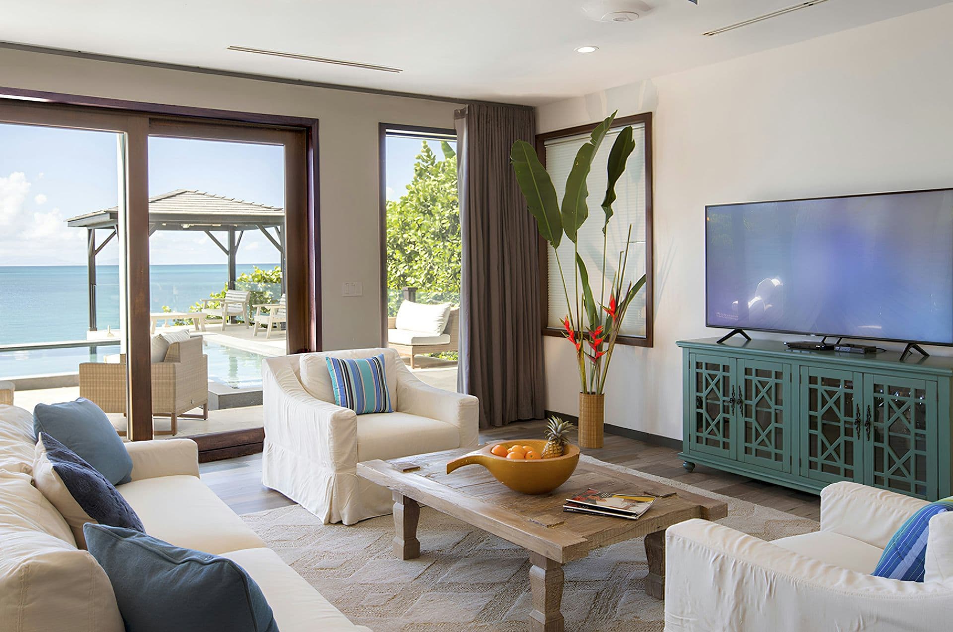 Bright living room with white sofas opening to the terrace at Life in Love, Antigua