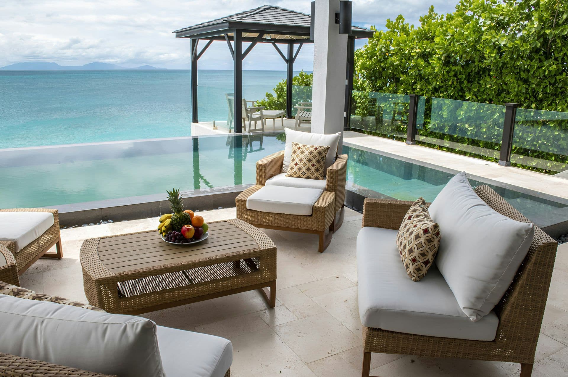 Infinity pool with a shaded gazebo and sea views at Life in Love, Antigua