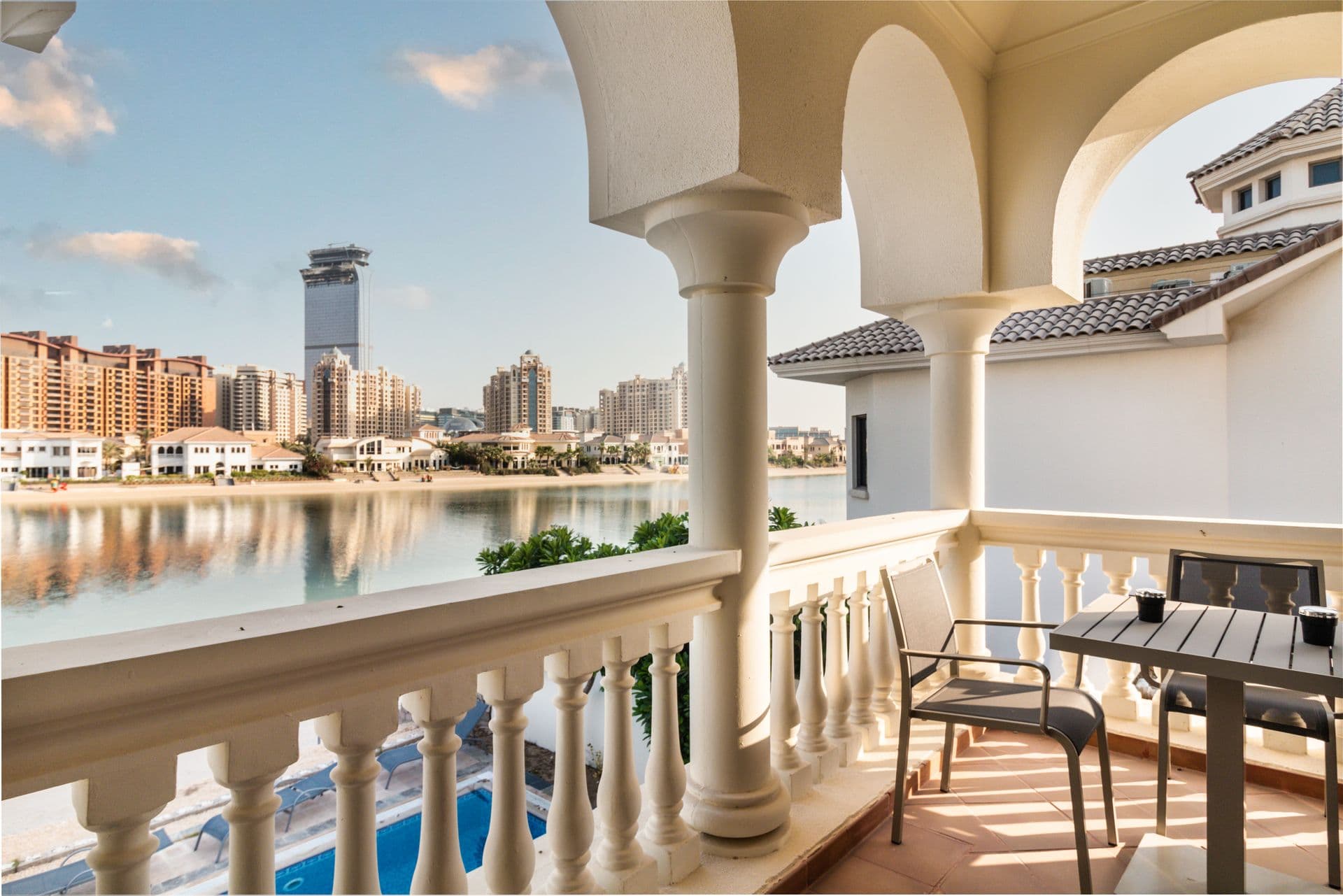 Balcony with seating overlooking the waterway and city skyline