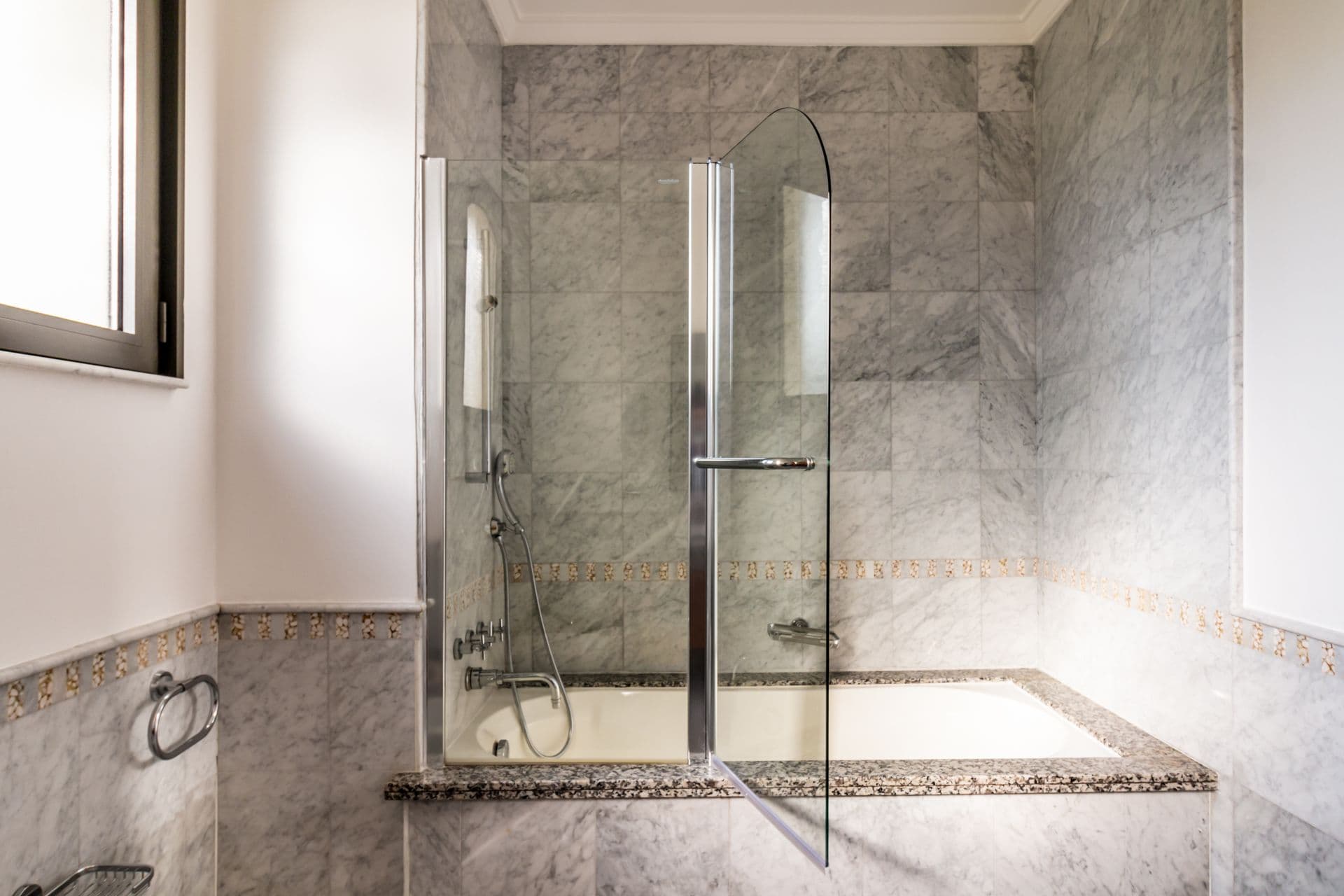 Marble bathroom with glass-enclosed walk-in shower