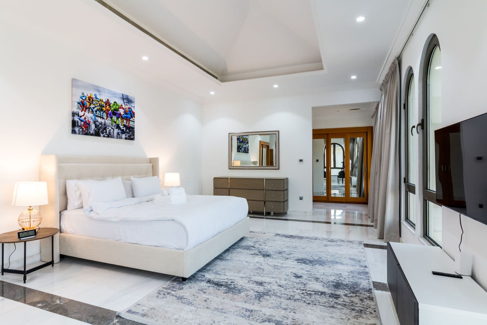 Bedroom with white upholstered bed and contemporary art print