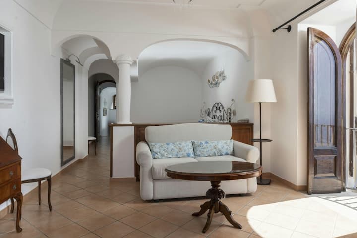 Sunny Positano Vista living room with vaulted ceilings and antique furniture, Positano, Amalfi Coast, Italy