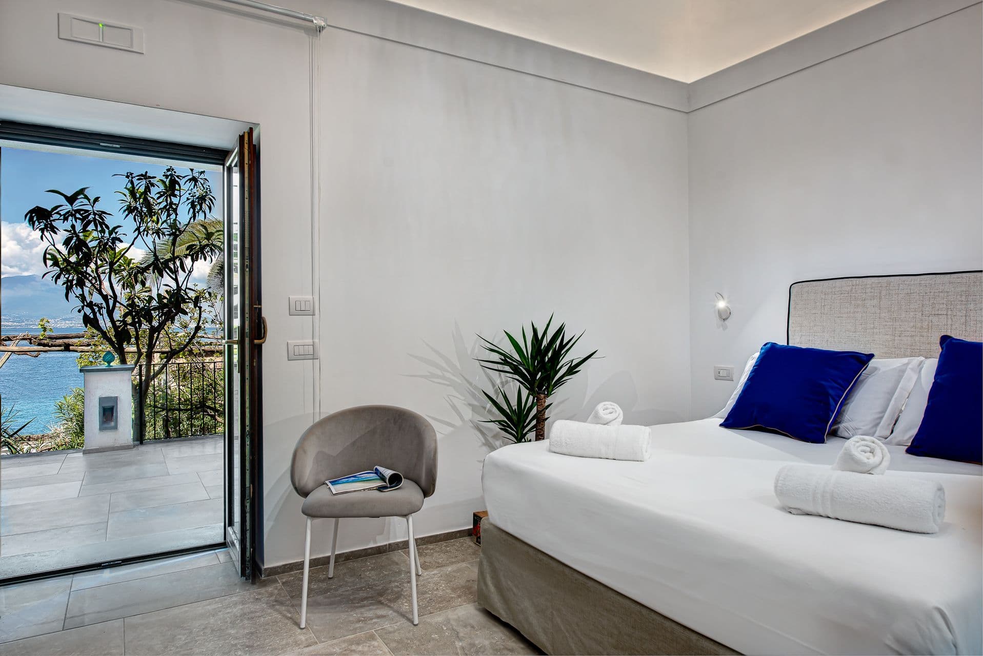 Bedroom with sliding glass doors opening onto a balcony with sea views at Mount of Love