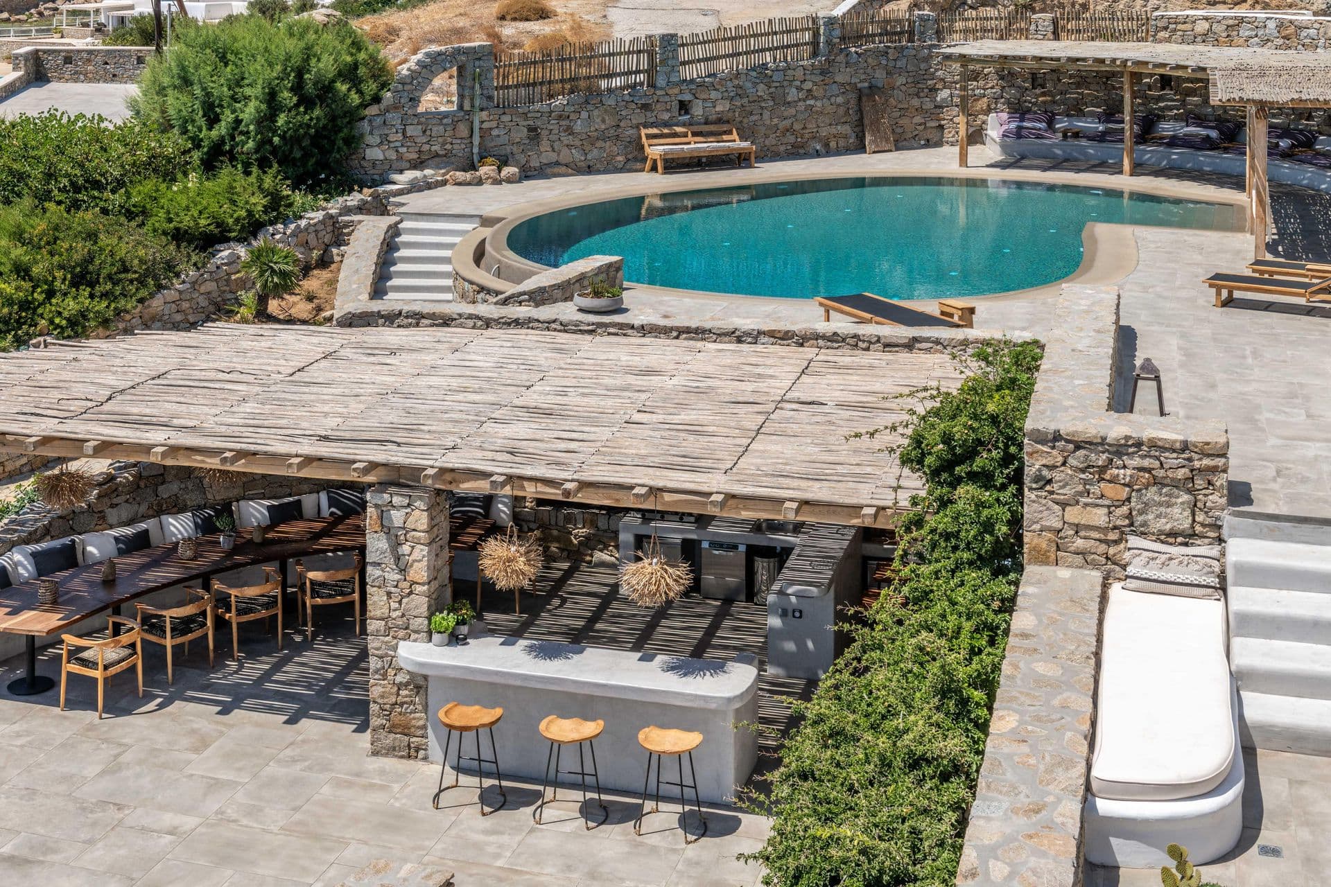 Aerial view of terraced pool deck and outdoor bar at Party Invitation villa