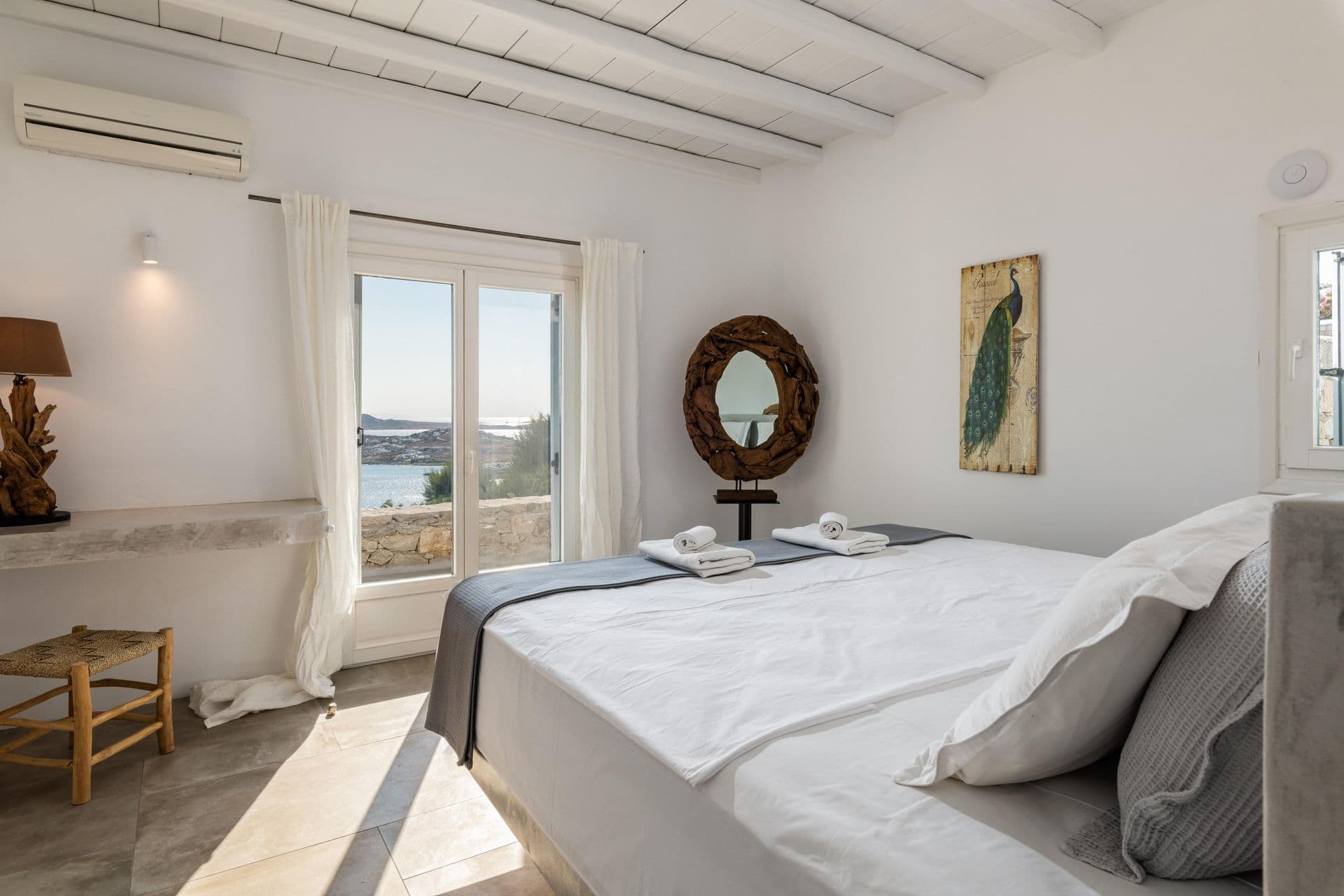 Bright bedroom with sea-view window at Party Invitation villa