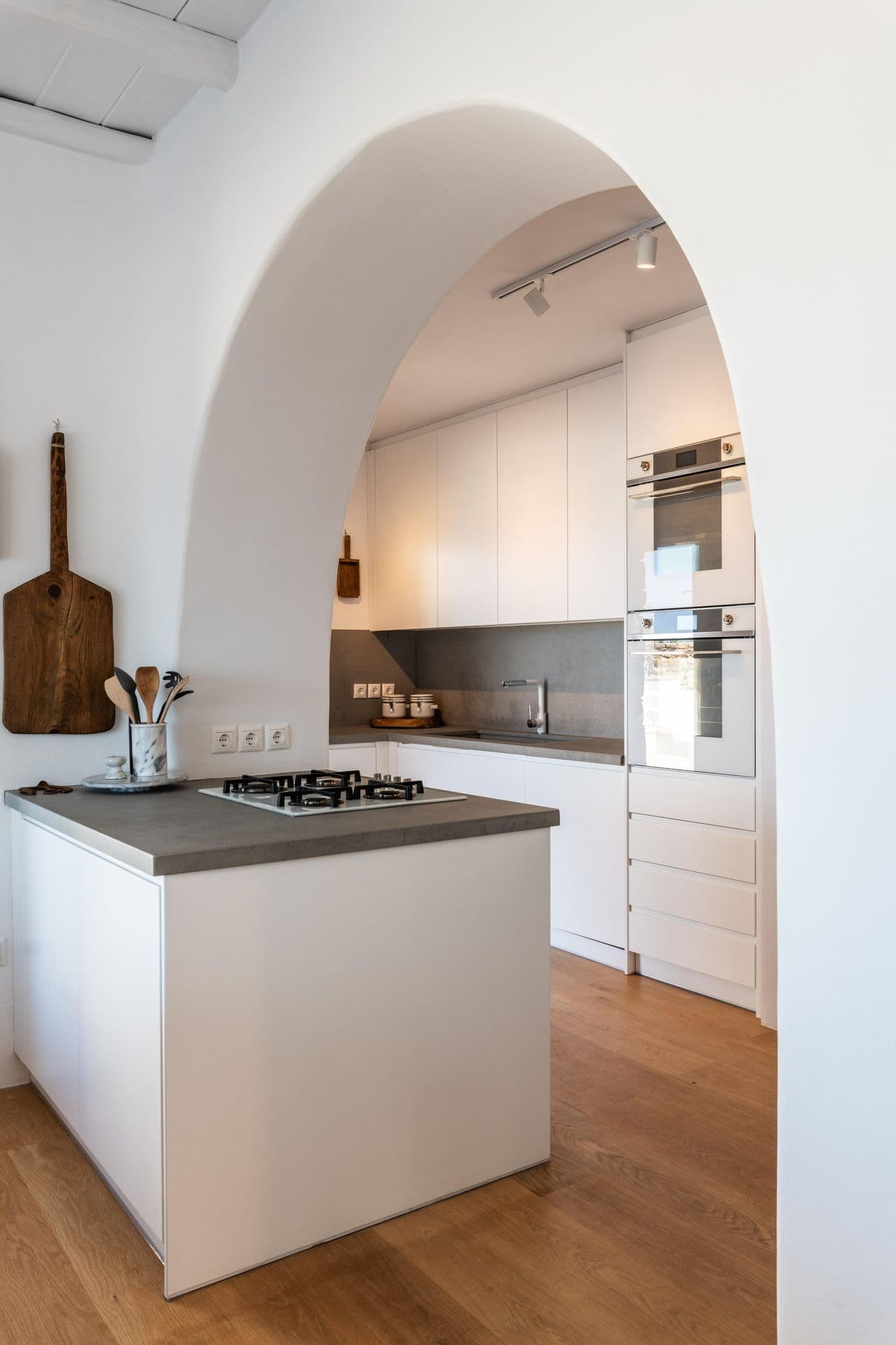 Modern white kitchen with island at Party Invitation villa