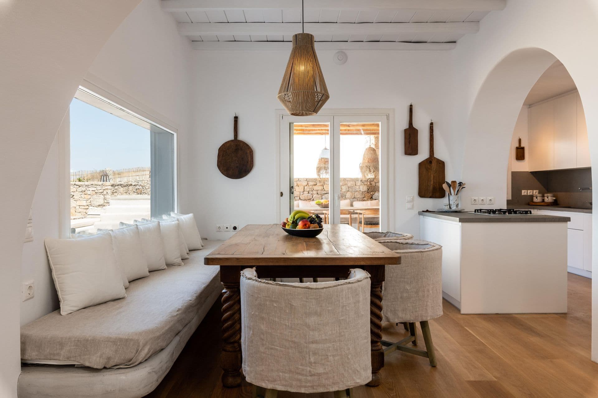 Open-plan living area with sea view and dining table at Party Invitation villa