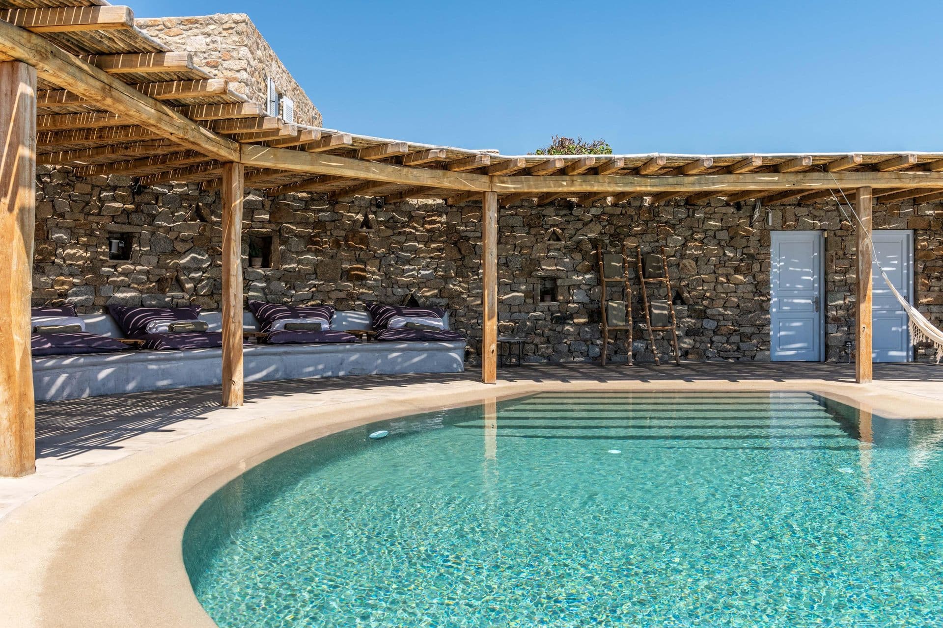 Poolside sun loungers and hammock beside the pool at Party Invitation