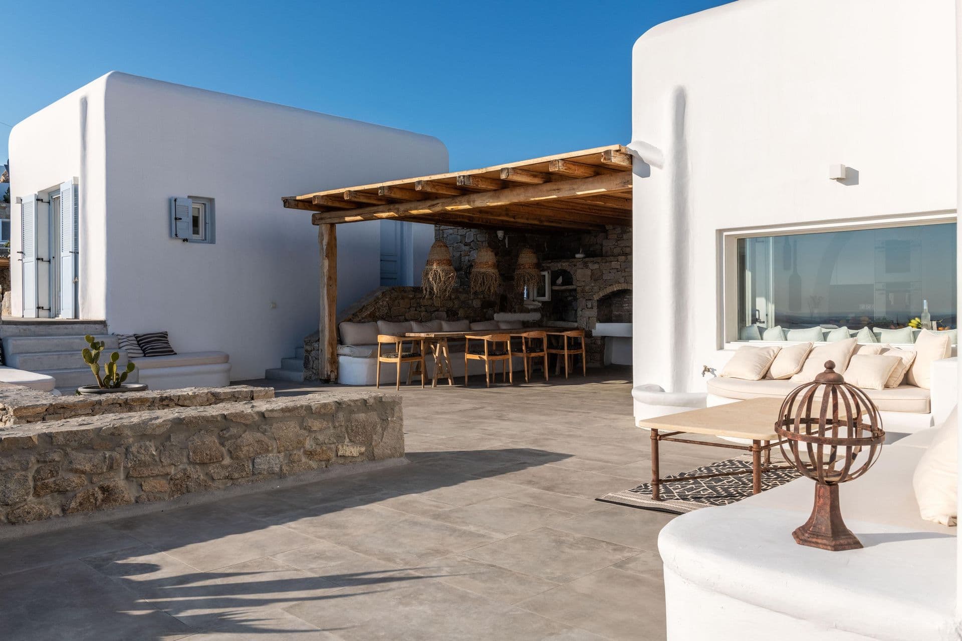 Terrace lounge and bar area with stone seating at Party Invitation villa