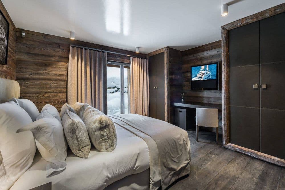Guest bedroom panelled in old timber at Mont d'Arbois 4