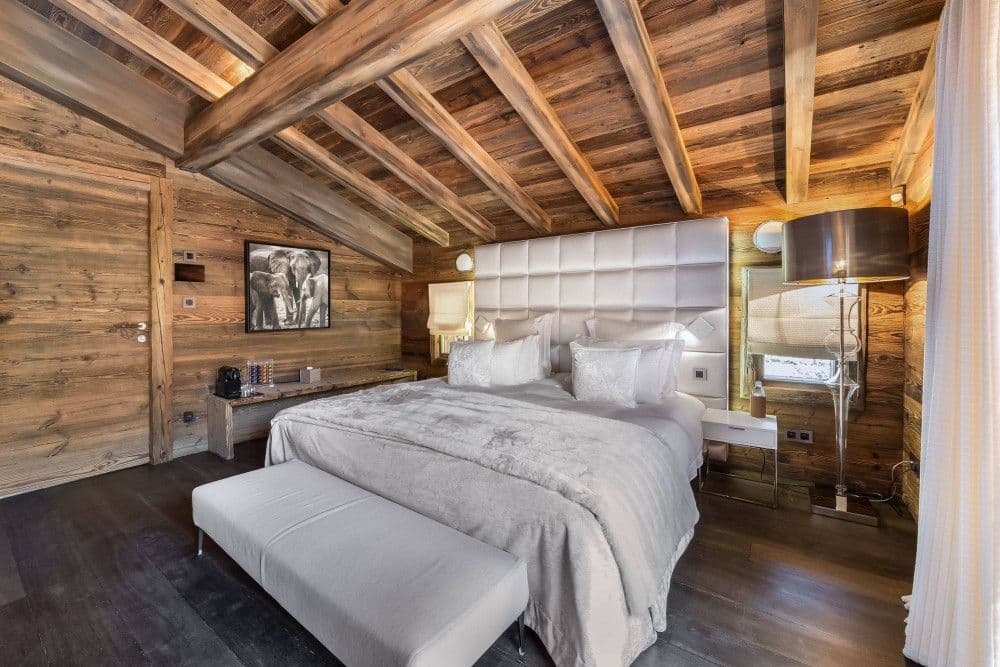 Master bedroom panelled in old timber at Mont d'Arbois 4