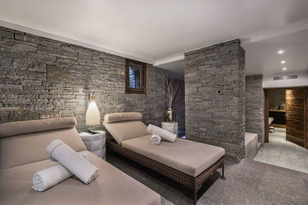 Spa relaxation area with loungers at Mont d'Arbois 4