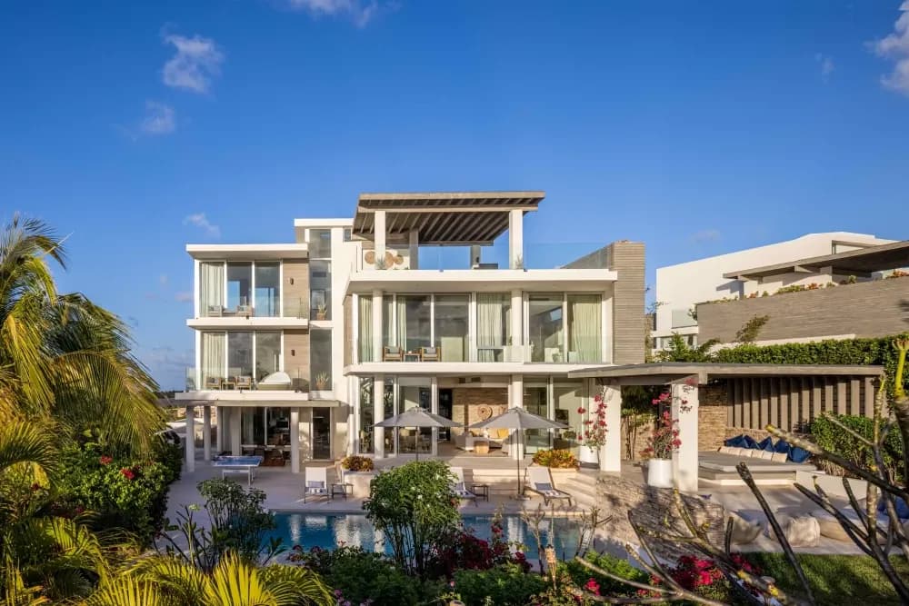 Contemporary white villa facade rising above the pool at Little Bay Villas