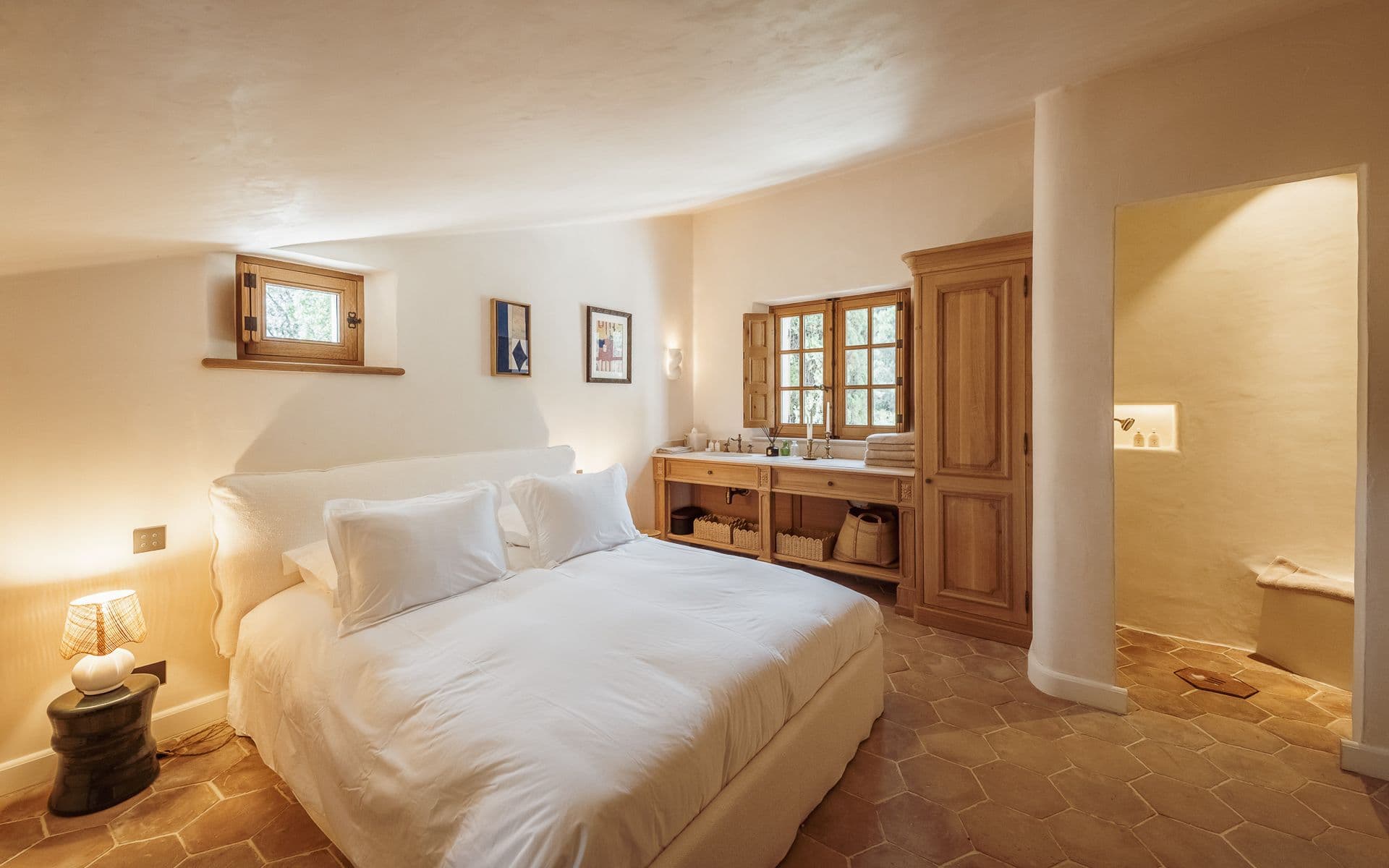Bedroom with wooden headboard, bedside lamps and built-in cabinetry