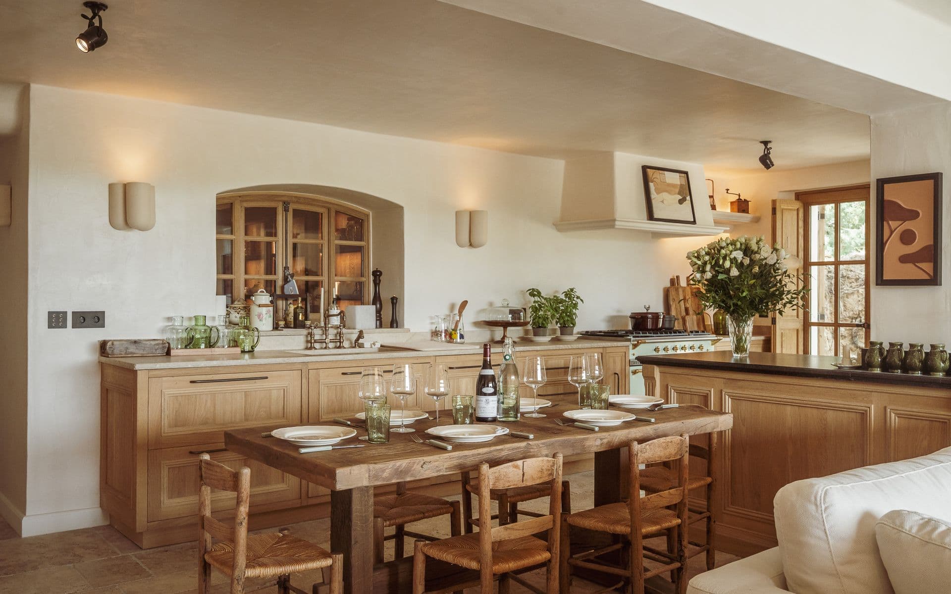 Rustic farmhouse kitchen with wooden dining table and fresh flowers
