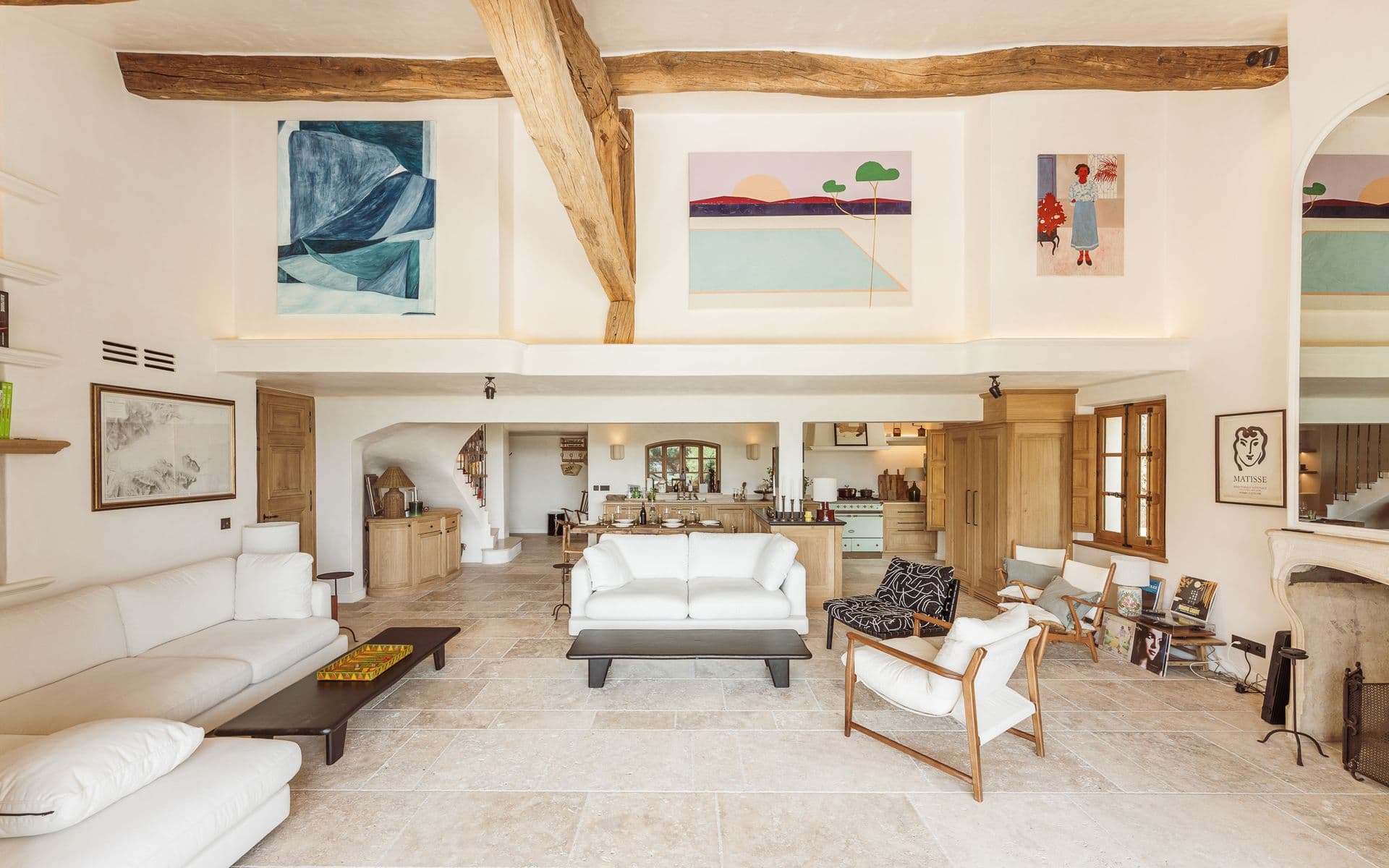 Double-height living room with vaulted ceiling and modern art above the sofas