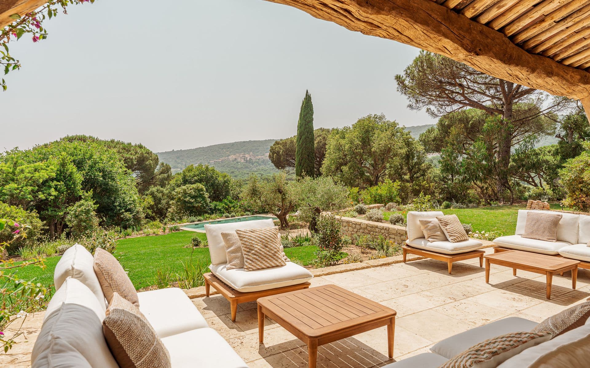Covered terrace with white sun loungers overlooking the Provencal countryside