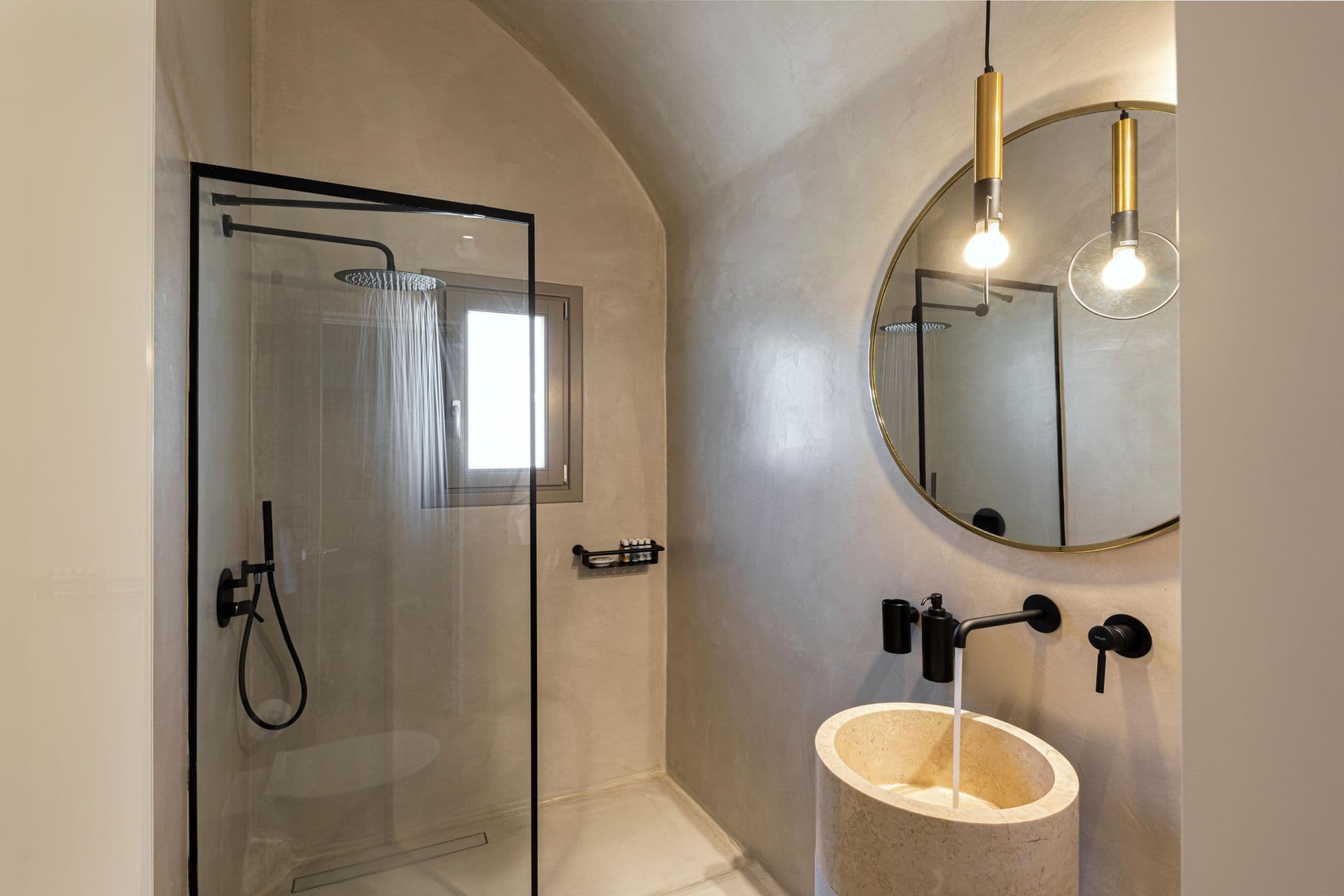 En-suite bathroom with rainfall shower and round mirror at Smile Upon You