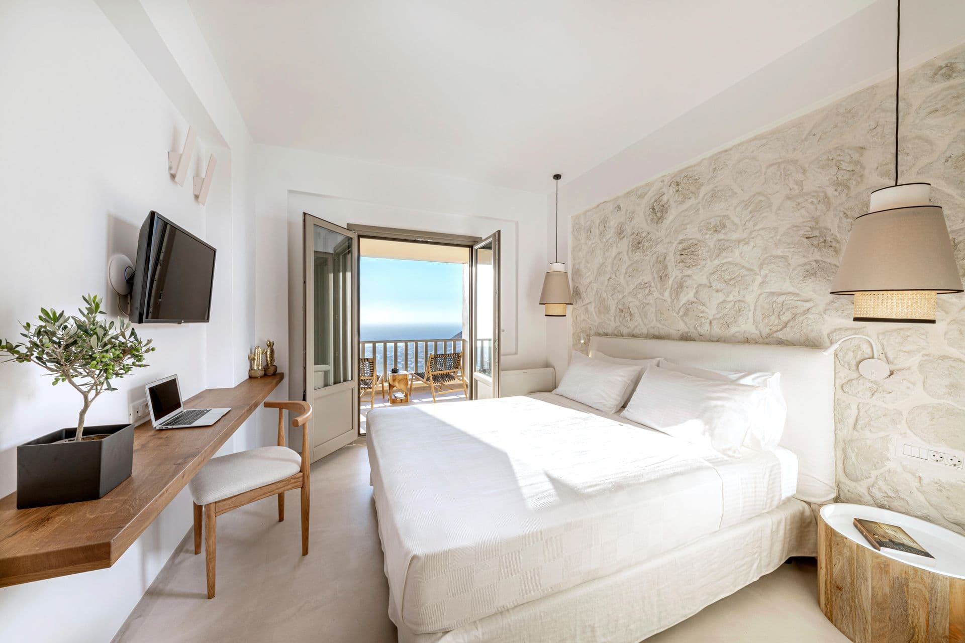 Guest bedroom with a work desk and private terrace access at Smile Upon You
