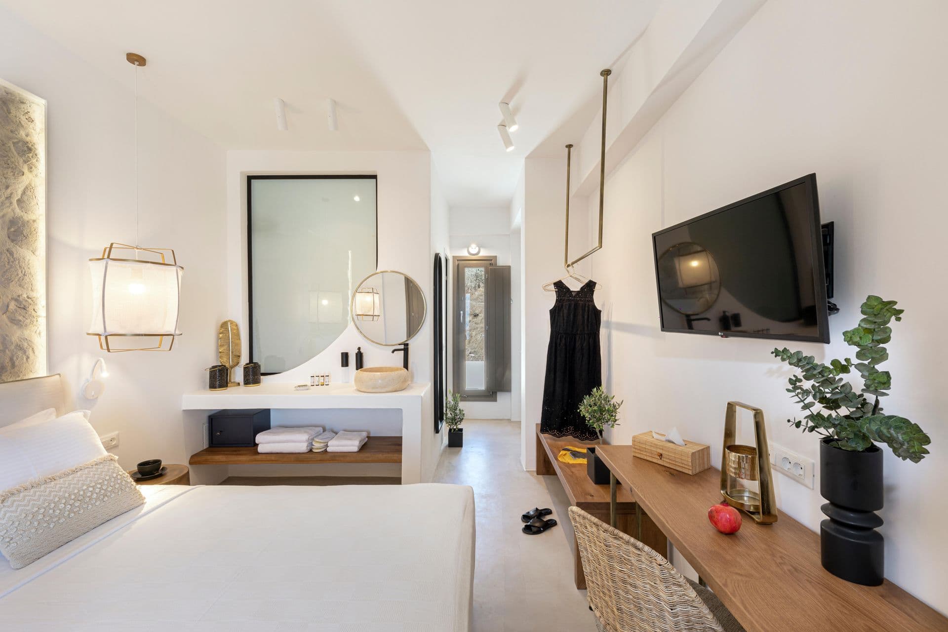 Guest bedroom with wall-mounted TV and view through to the en-suite at Smile Upon You