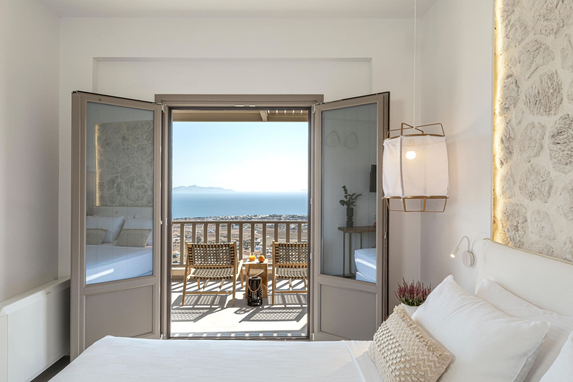 Guest bedroom opening onto a private terrace with sea views at Smile Upon You