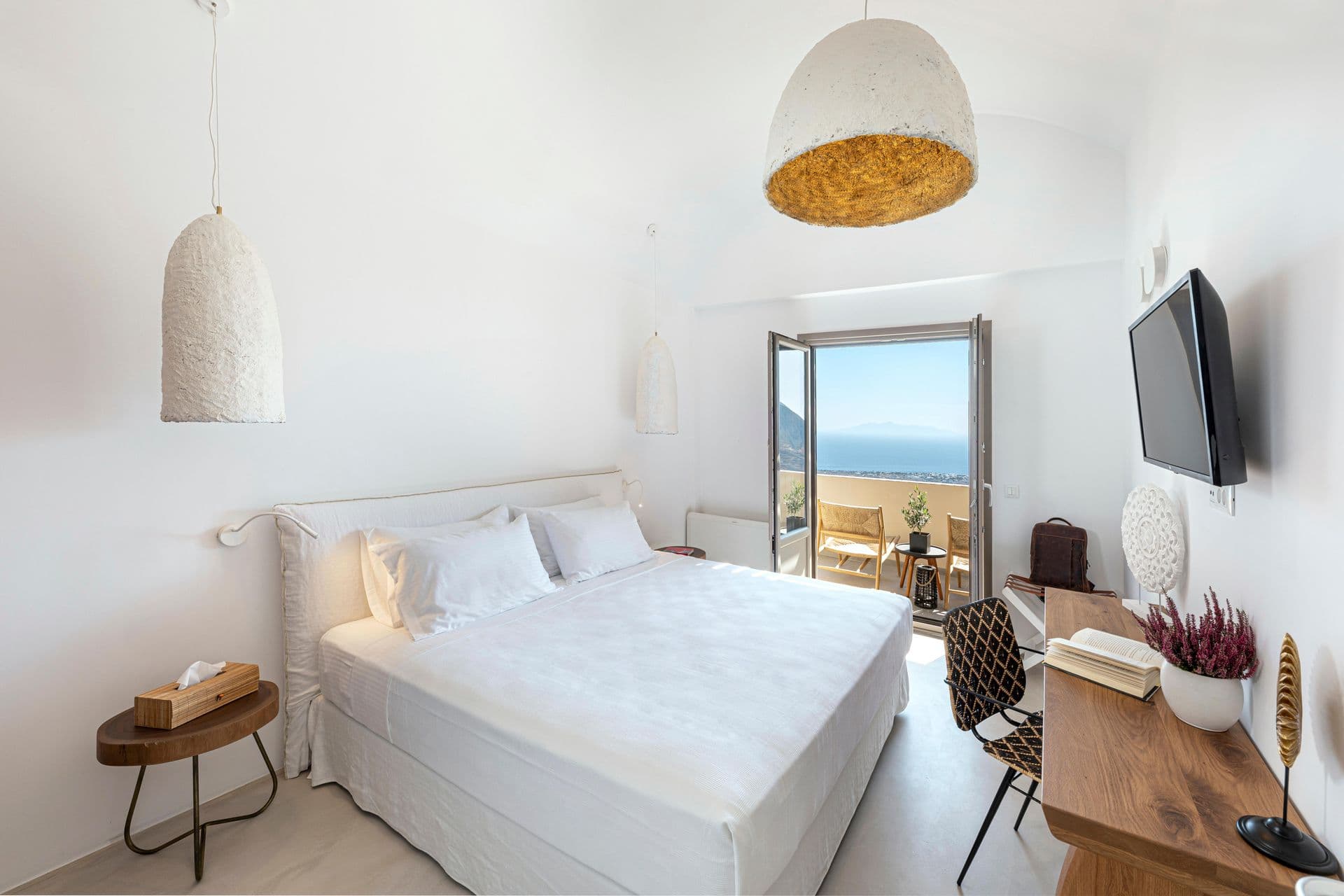 Guest bedroom with woven pendant lighting and sea-view patio doors at Smile Upon You