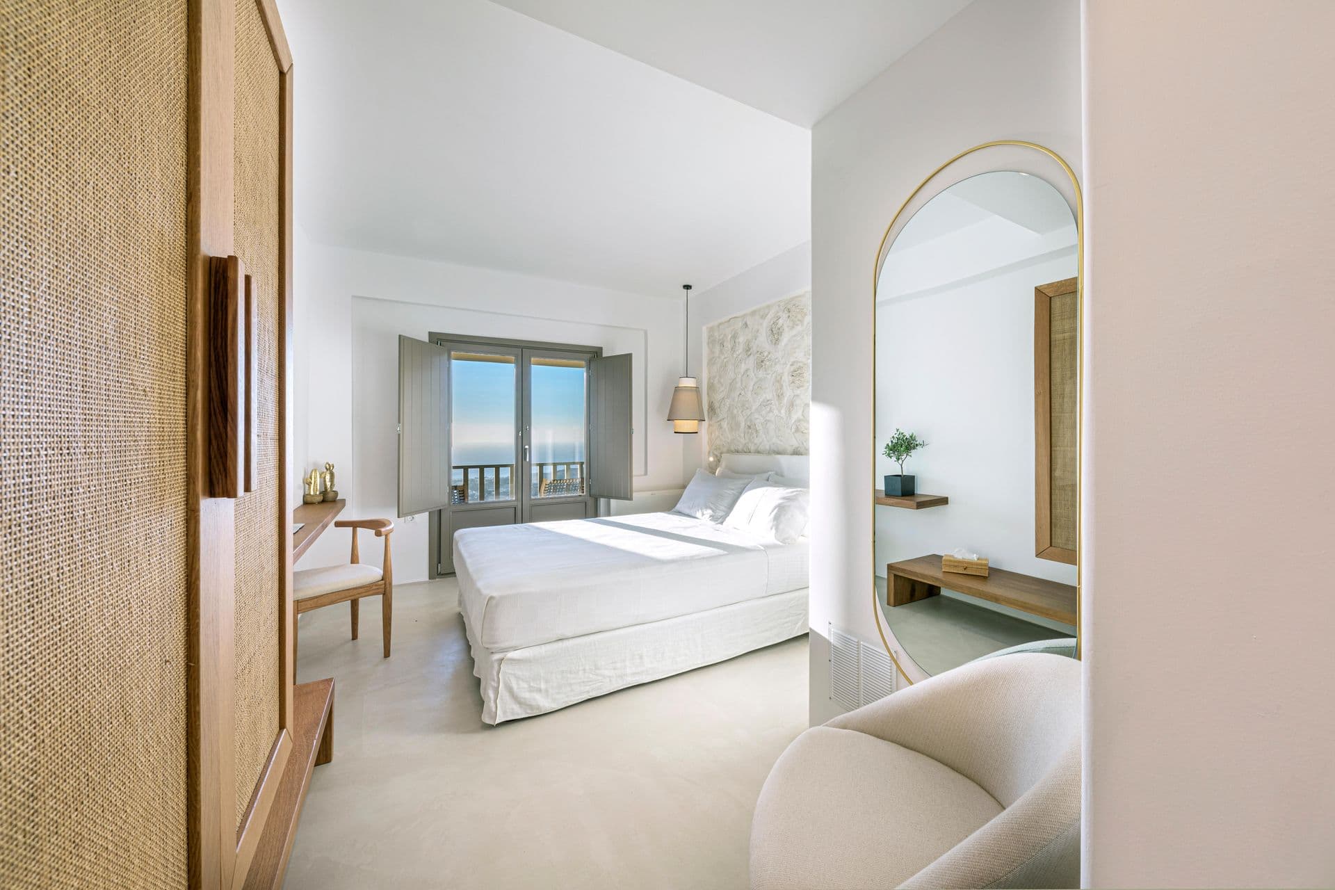 Guest suite with woven wardrobe and arched mirror at Smile Upon You
